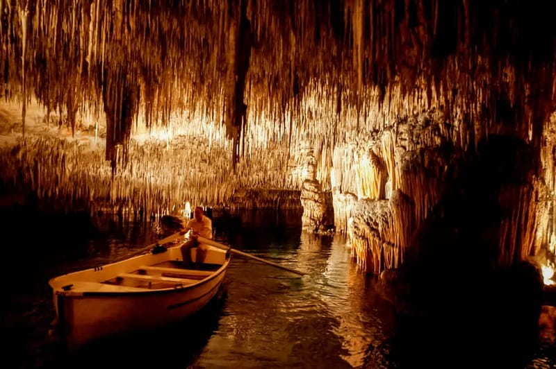 Alcudia: Caves of Drach Tour from the North with Boat Trip - The wooden boat ride across the underground lake