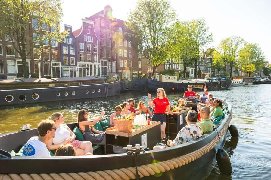 Amsterdam: Guided Open Boat Cruise Unlimited Drinks Option - The first stretch: Centraal Station, Sea Palace, and the old harbor