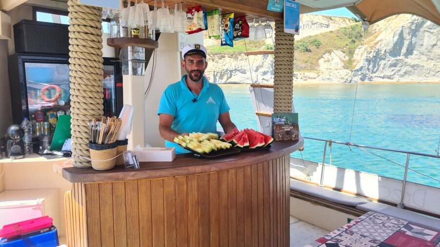 Argostoli: Full-Day Traditional Boat Cruise with Lunch - Life onboard: swimming gear, drinks, and a social atmosphere