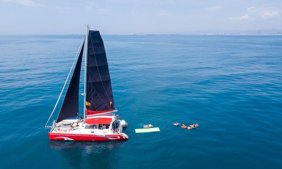 Barcelona: Sunset or Day Catamaran Cruise with Tapa & Drink - The daytime route and its 30-minute Mediterranean swim