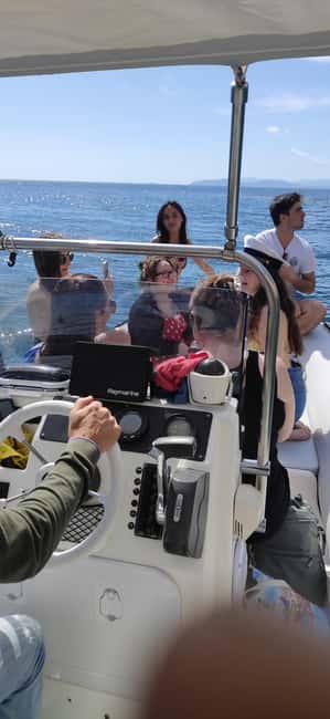 Cagliari: Sella del Diavolo Boat Magic Tour Drinks & Snacks - Captain Valter, music, and the social side
