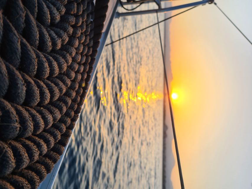 Cambrils: Costa Dorada Sunset Catamaran Cruise with Drinks - Drinks, music, and the return to Cambrils