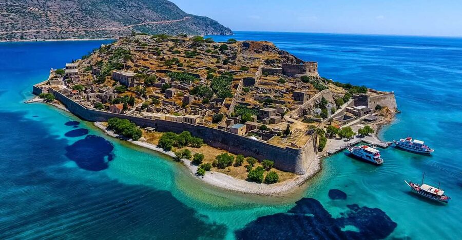 Crete: Spinalonga, Elounda, & Agios Nikolaos Boat Tour & BBQ - Kolokytha Beach, clear water, and lunch on the boat