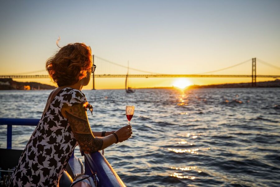 Lisbon: Sunset Cruise with Live DJ and Drinks - Under the 25th April Bridge toward Cristo Rei