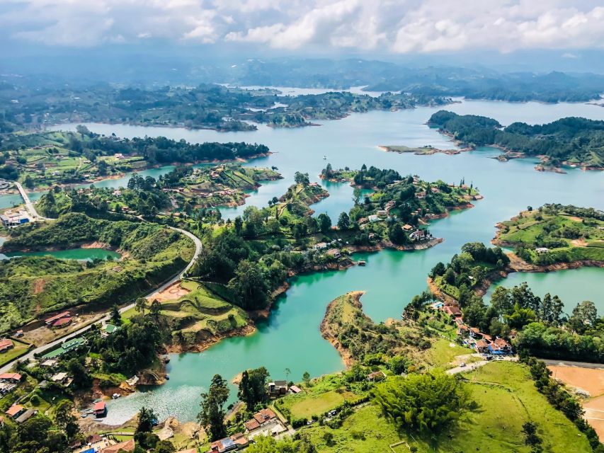 Medellin: Guatapé Day Trip & Boat to Pablo Escobar's Estate - Guatapé’s painted streets and umbrella photos