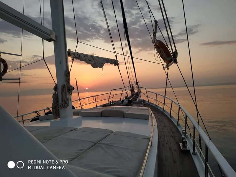 Mykonos: Sunset Boat Cruise with Light Dinner & Drinks - Sunset on the return to Mykonos