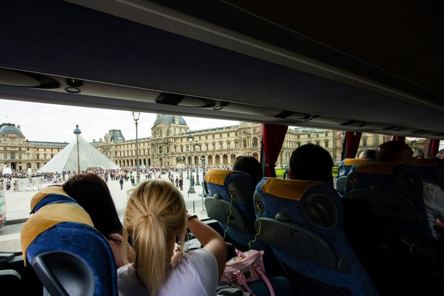 Paris: Audio-Guided Bus Tour & Seine River Cruise - Boarding the Seine cruise near the Eiffel Tower