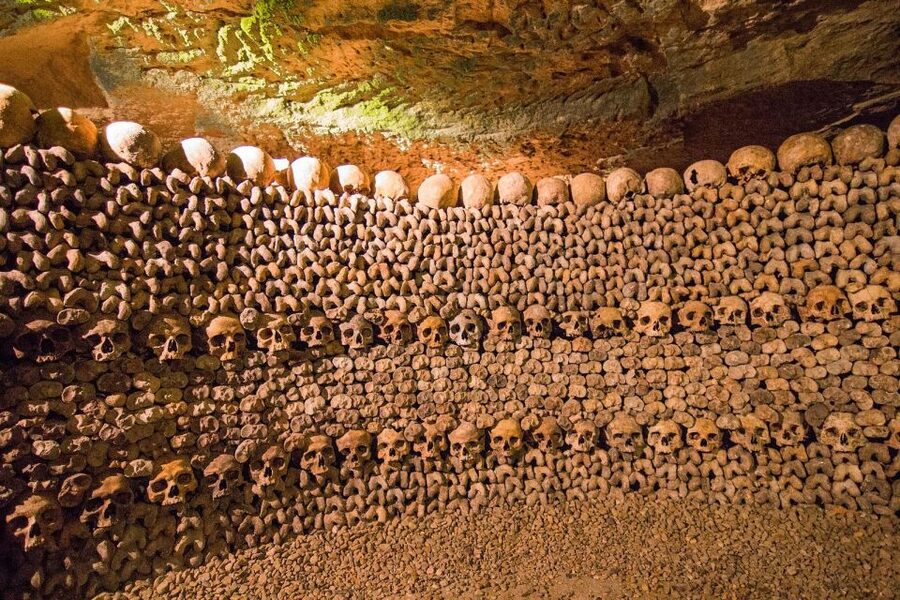 Paris: Catacombs Entry & Seine River Cruise with Audio Guide - Walking through the Paris Catacombs