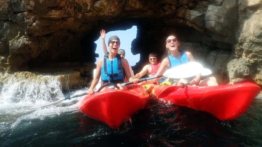 Pula: Sea Adventure – Boat, Kayak, Snorkeling & Cliff Jumps - Paddling beneath the Muzil cliffs