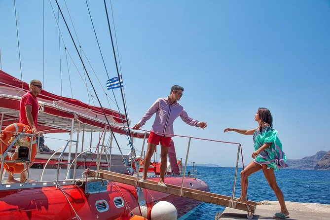 Sailing Catamaran Cruise in Santorini with BBQ, Drinks and Transfer - Red Beach, volcanic colors and clear water