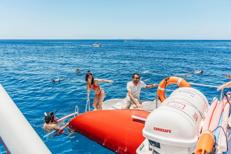 Santorini: Catamaran Tour with BBQ Dinner, Drinks, and Music - Hot springs first, with a volcanic backdrop