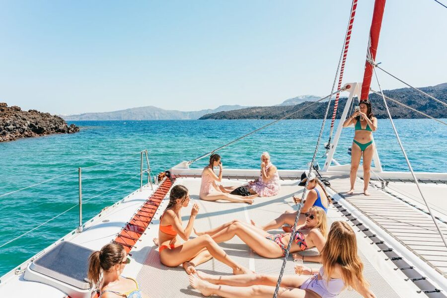 Santorini: Catamaran Tour with BBQ Dinner, Drinks, and Music - Red Beach and White Beach from the water