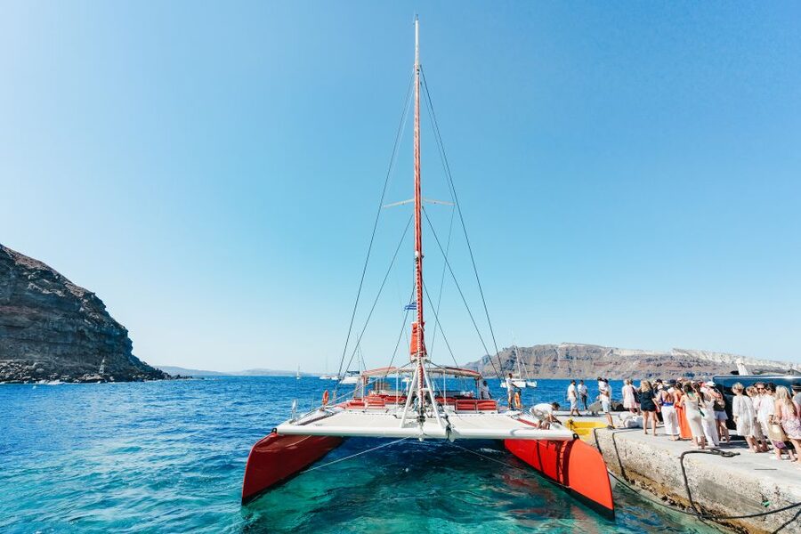 Santorini: Catamaran Tour with BBQ Dinner, Drinks, and Music - Pickup, boarding, and the two catamarans