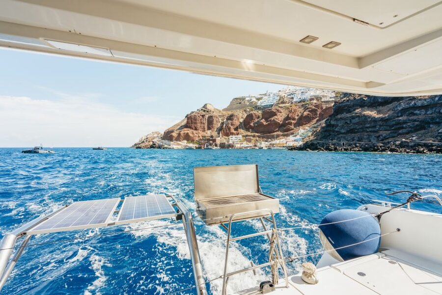 Santorini: Luxury Catamaran Day Trip with Meal and Open Bar - Crew, music, and the feel on board