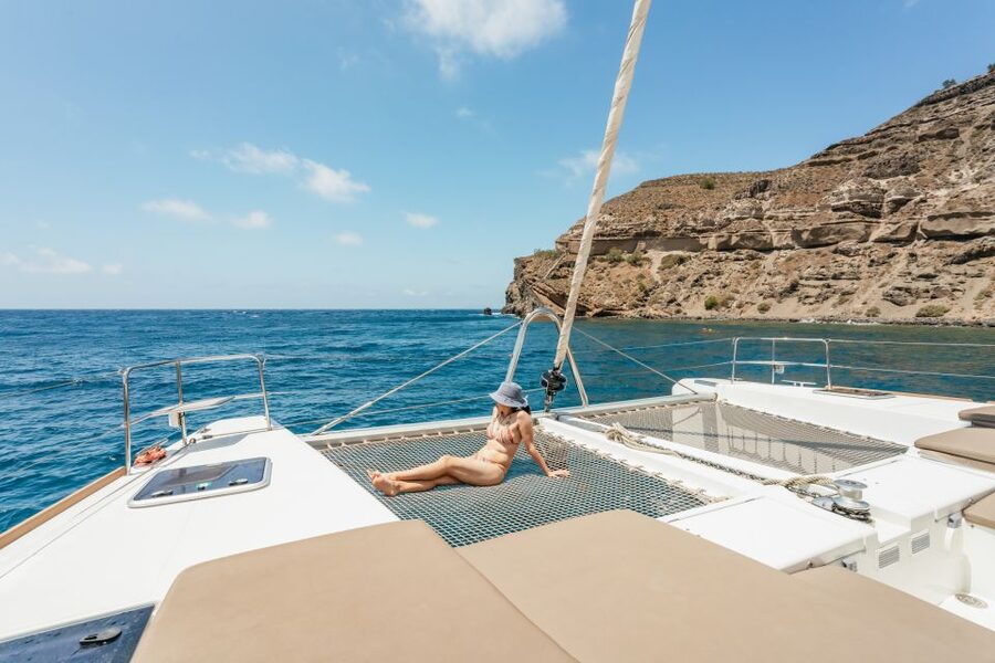 Santorini: Luxury Catamaran Day Trip with Meal and Open Bar - Pickup, port transfer, and the first hour aboard
