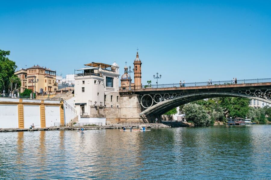 Seville: 1-Hour Guadalquivir River Sightseeing Eco Cruise - Old towers beside newer riverfront design