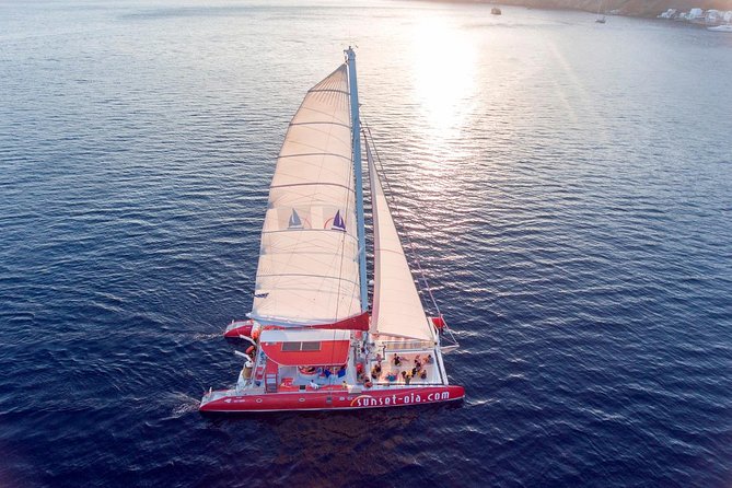 Sunset Sailing Catamaran Cruise in Santorini with BBQ and Drinks - Sunset near Oia, with a timing warning