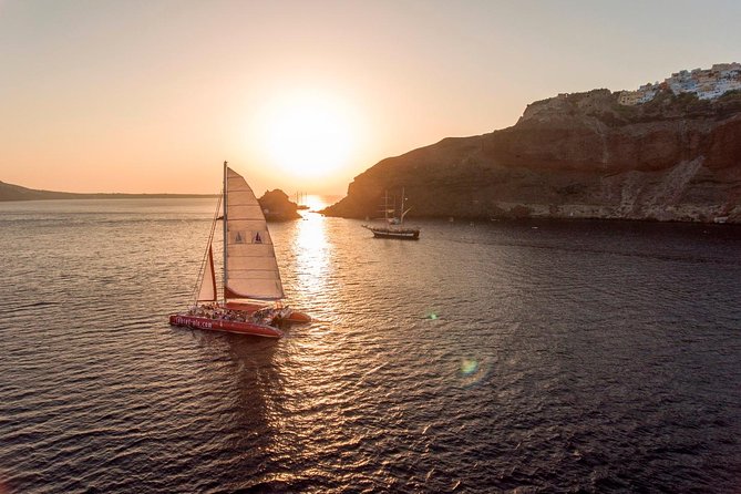 Sunset Sailing Catamaran Cruise in Santorini with BBQ and Drinks - Red Beach from the water